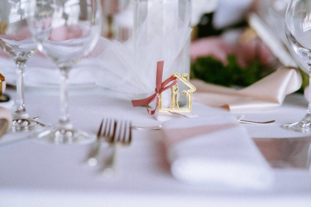 A beautifully arranged wedding table with elegant cutlery and glassware, adorned with decorative elements.